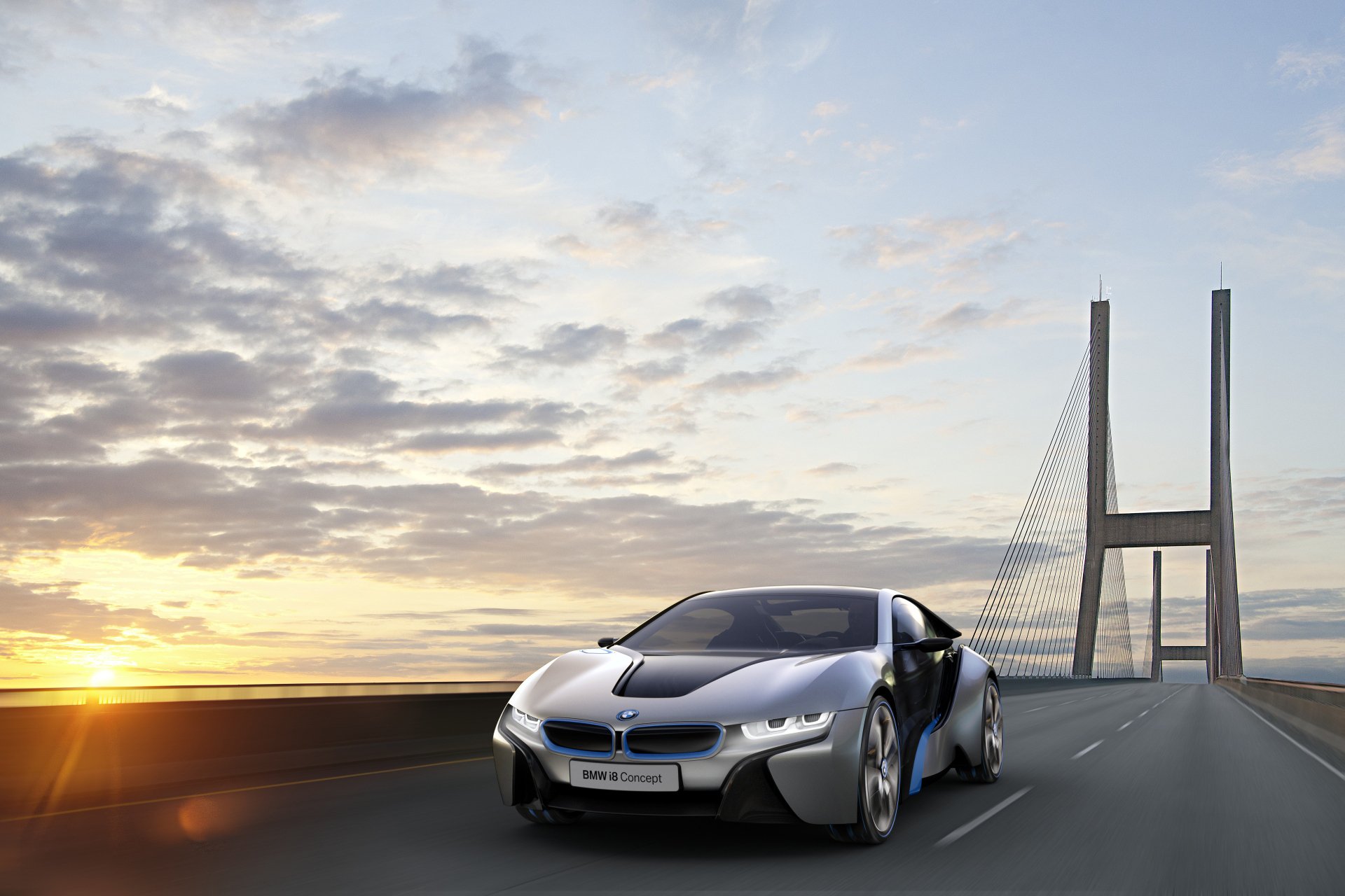 HD PC desktop wallpaper background of a sleek silver BMW i8 sports vehicle driving across a bridge at sunrise beneath a dramatic cloudy sky.