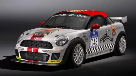 HD PC desktop wallpaper of a sports car: silver-red Mini coupe race vehicle with decals, number 149, checkered side graphics and sponsor logos on a neutral studio background.