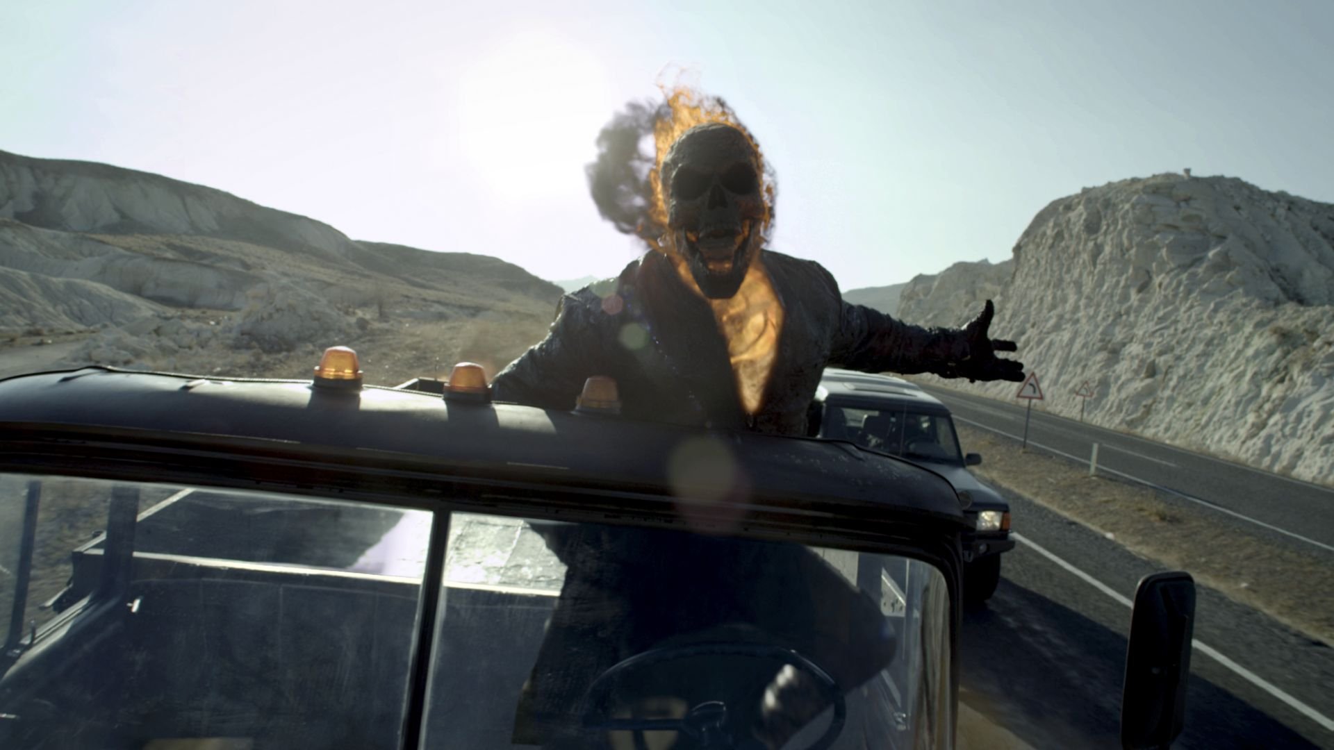 HD PC desktop wallpaper featuring Ghost Rider from the movie Ghost Rider: Spirit of Vengeance, with the flaming skull character riding on a vehicle in a desert landscape.