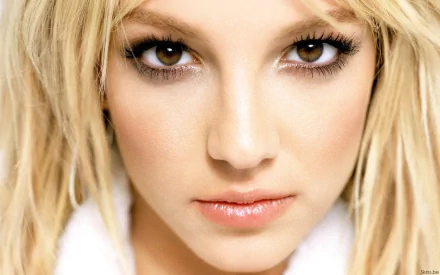 Close-up of Britney Spears, showcasing her striking features and captivating gaze. This high-definition wallpaper captures her iconic look in music.