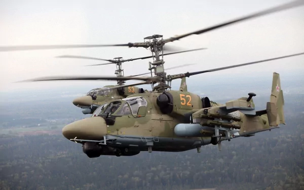 HD desktop wallpaper featuring two Kamov Ka-52 military helicopters flying over a forested landscape.