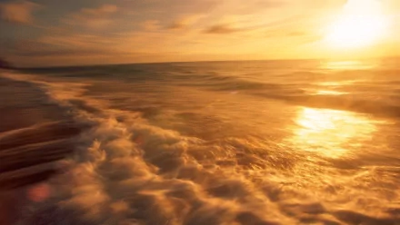 HD PC desktop wallpaper and background — nature seascape of sunlit waves washing the shore beneath a golden sunset.