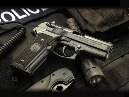 HD desktop wallpaper featuring a man-made Beretta 8000 Cougar pistol resting on tactical gear with a police patch visible in the background.