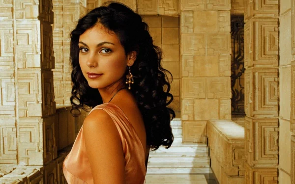 HD PC desktop wallpaper featuring celebrity Morena Baccarin posing against an ornate stone architectural background.