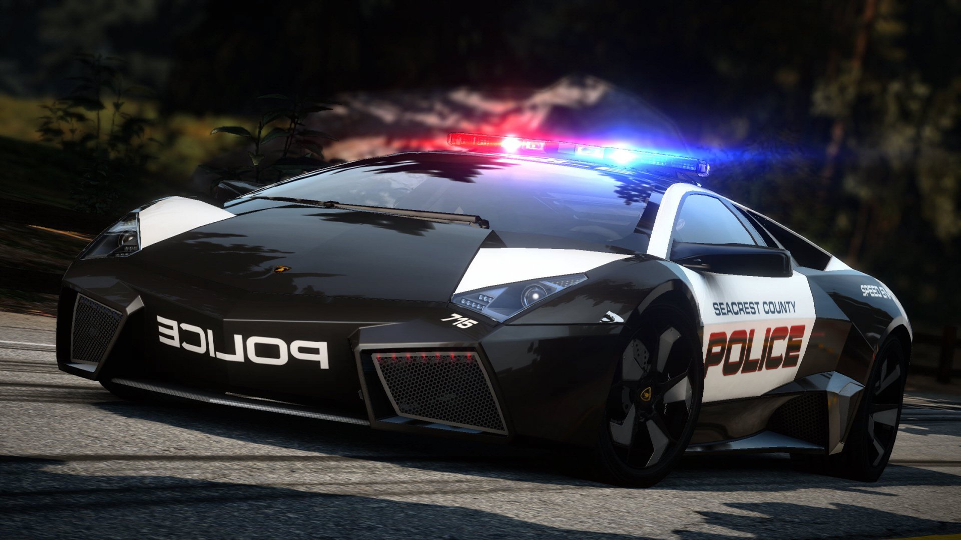 HD PC desktop wallpaper featuring a sleek police car from the video game Need For Speed, illuminated by red and blue lights on a dynamic nighttime road.