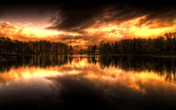 Scenic nature view of a calm lake reflecting a dramatic sunset sky, captured in HD for PC desktop wallpaper and background.