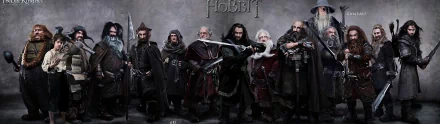 HD PC desktop wallpaper featuring the main characters from the movie The Hobbit: An Unexpected Journey, showcasing seven dwarves in detailed costumes with weapons.