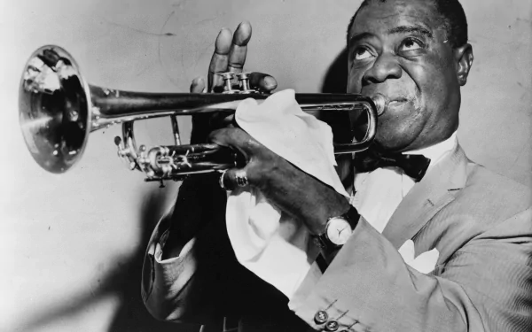 Black and white HD wallpaper of Louis Armstrong playing the trumpet, capturing the essence of classic jazz music for PC desktops.