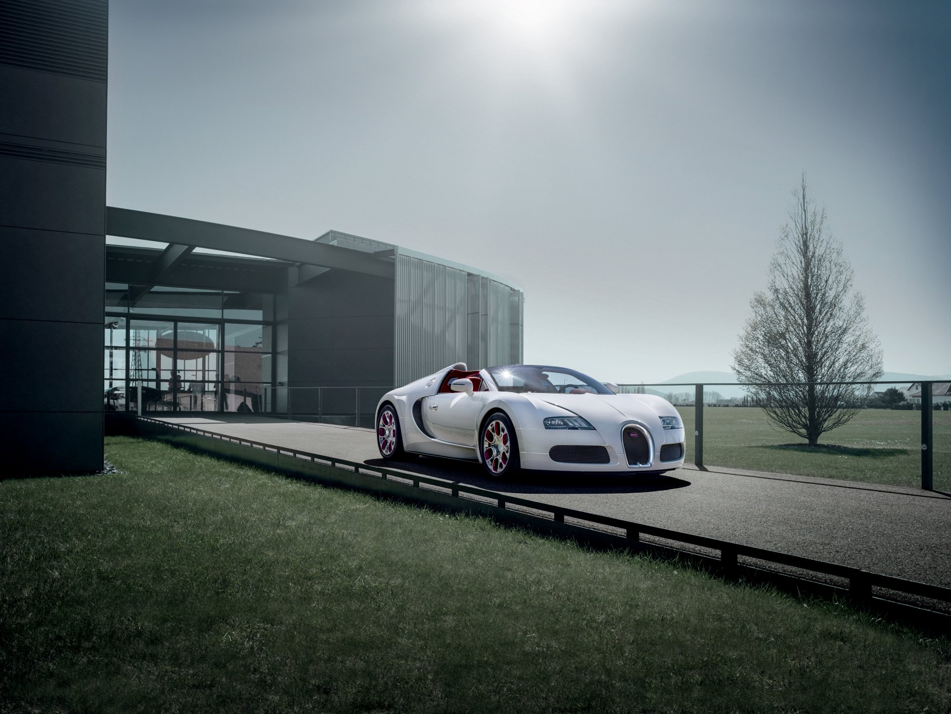 A sleek white Bugatti Veyron parked on a modern driveway under a cloudy sky, captured in 4K Ultra HD for a PC desktop wallpaper.