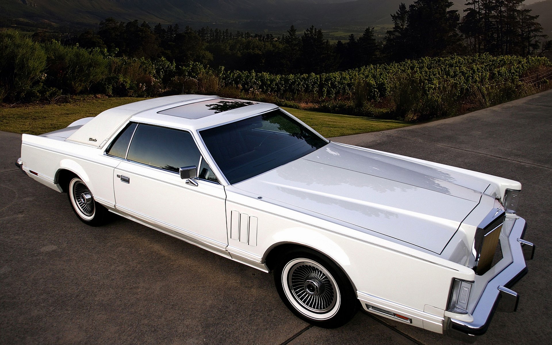 White classic Lincoln coupe parked on a country road at dusk — 2K Quad HD PC desktop wallpaper and background showcasing vintage vehicle details and chrome accents
