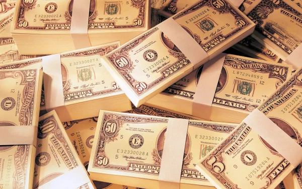 A high-definition desktop wallpaper featuring stacks of neatly arranged dollar bills, showcasing the intricate details of the currency in a visually appealing composition.