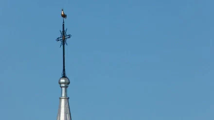 Religious church spire with ornate cross silhouetted against a clear blue sky — 4K Ultra HD PC desktop wallpaper and background.