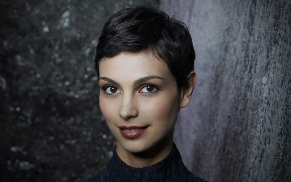 HD desktop wallpaper featuring celebrity Morena Baccarin with short hair, smiling softly against a textured dark background.