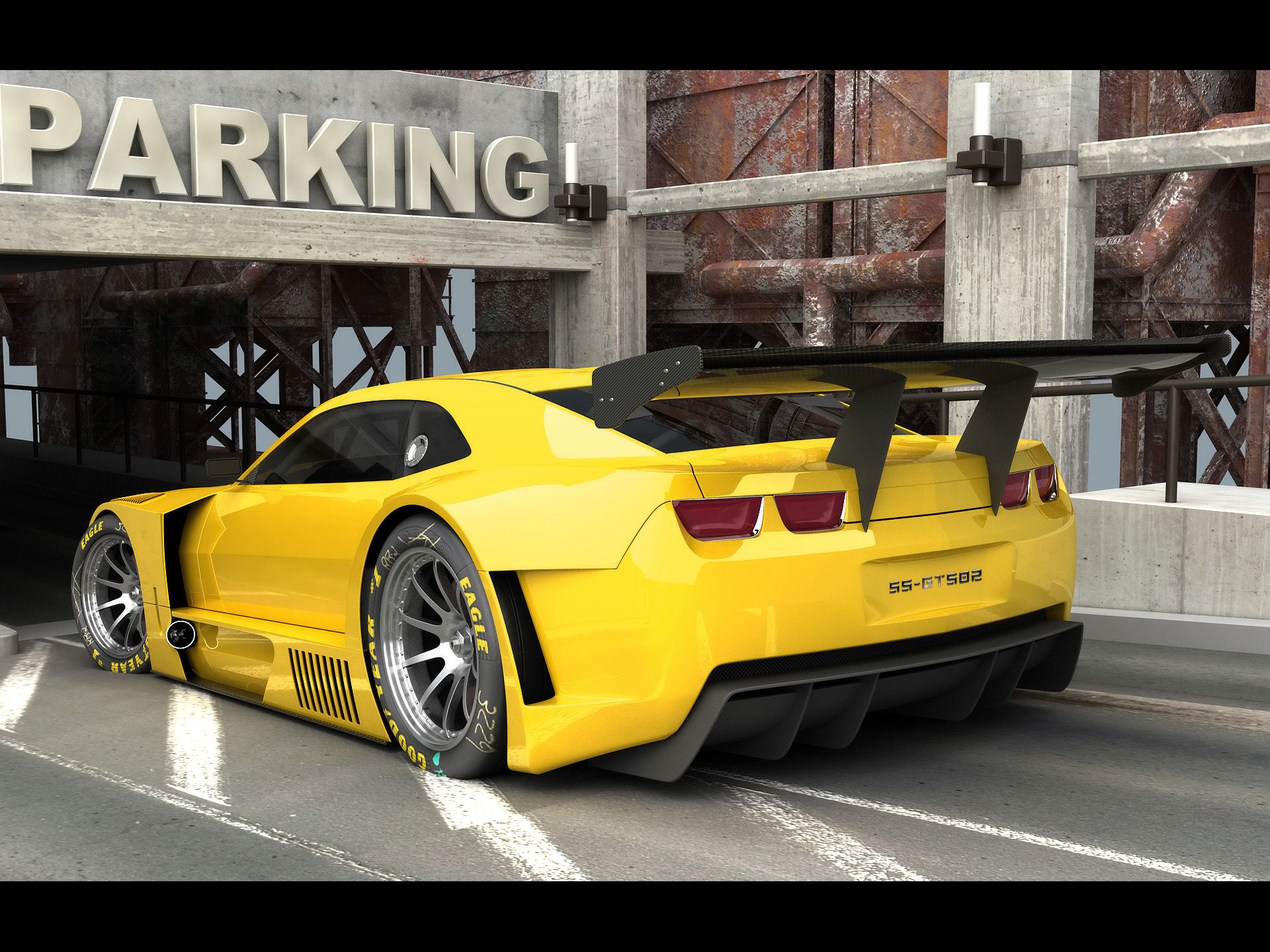 Yellow Chevrolet Camaro vehicle parked in an industrial lot, rear three-quarter view with large spoiler and wide wheels — HD PC desktop wallpaper/background.