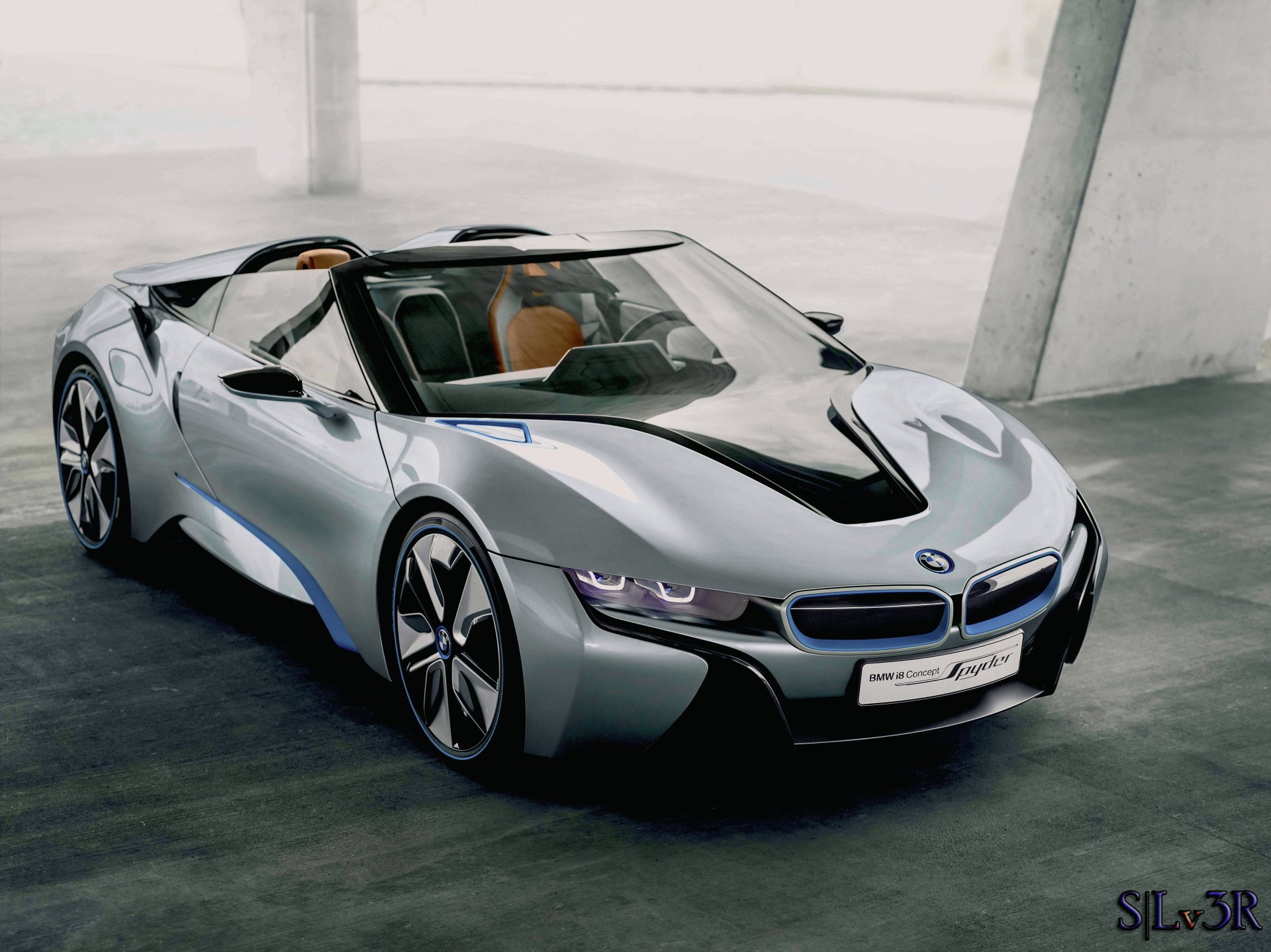 A sleek BMW i8 convertible showcased in a contemporary setting, highlighting its modern design. This HD wallpaper captures the essence of luxury and high-performance vehicles.