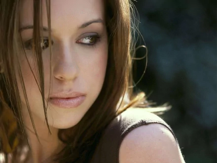 Close-up of a thoughtful young woman with long hair, evoking a dreamy atmosphere, suitable as a desktop wallpaper featuring the essence of celebrity and glamour.