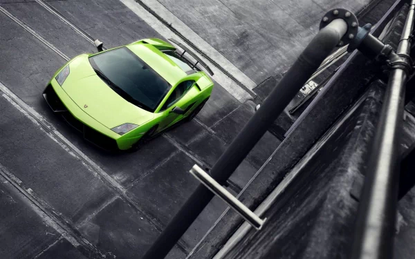 Top-down view of a lime green Lamborghini Gallardo Superleggera on an industrial concrete rooftop, HD PC desktop wallpaper with dramatic high-contrast lighting.