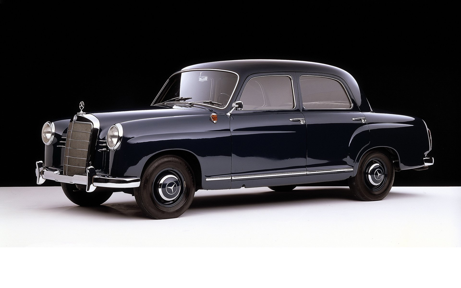 Classic Mercedes sedan in glossy dark blue, side profile on a black backdrop — HD PC desktop wallpaper and background.