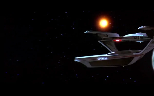 HD desktop wallpaper featuring the starship Enterprise from Star Trek III: The Search for Spock against a backdrop of stars and a glowing sun.