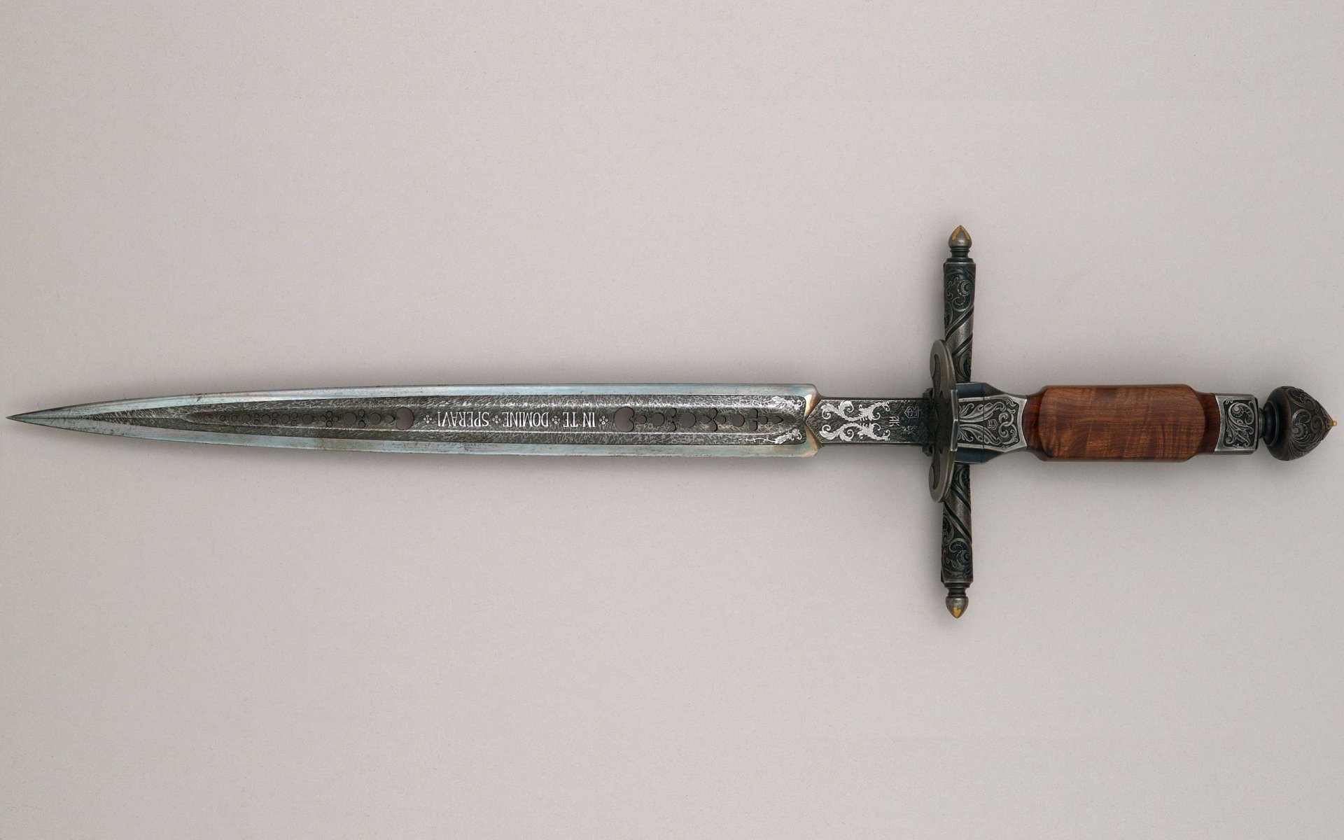 A detailed image of a man-made sword with a polished blade and ornate hilt, designed to serve as an HD desktop wallpaper or background, showcasing craftsmanship and elegance.
