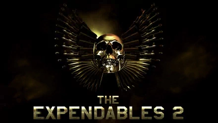 HD desktop wallpaper featuring a gold skull with wings made of bullets and The Expendables 2 movie title against a dark background.