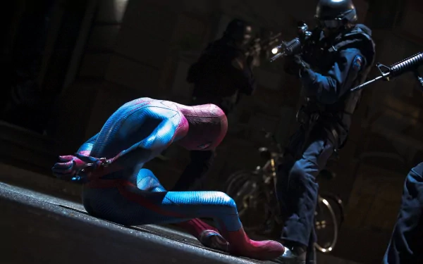 A dramatic scene from *The Amazing Spider-Man*, featuring Spider-Man on the ground as a masked figure approaches with a weapon, set against a dark urban backdrop. HD desktop wallpaper.
