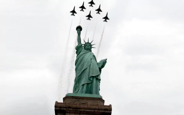 HD PC desktop wallpaper: USAF Thunderbirds jets in formation over the Statue of Liberty during a military air show.
