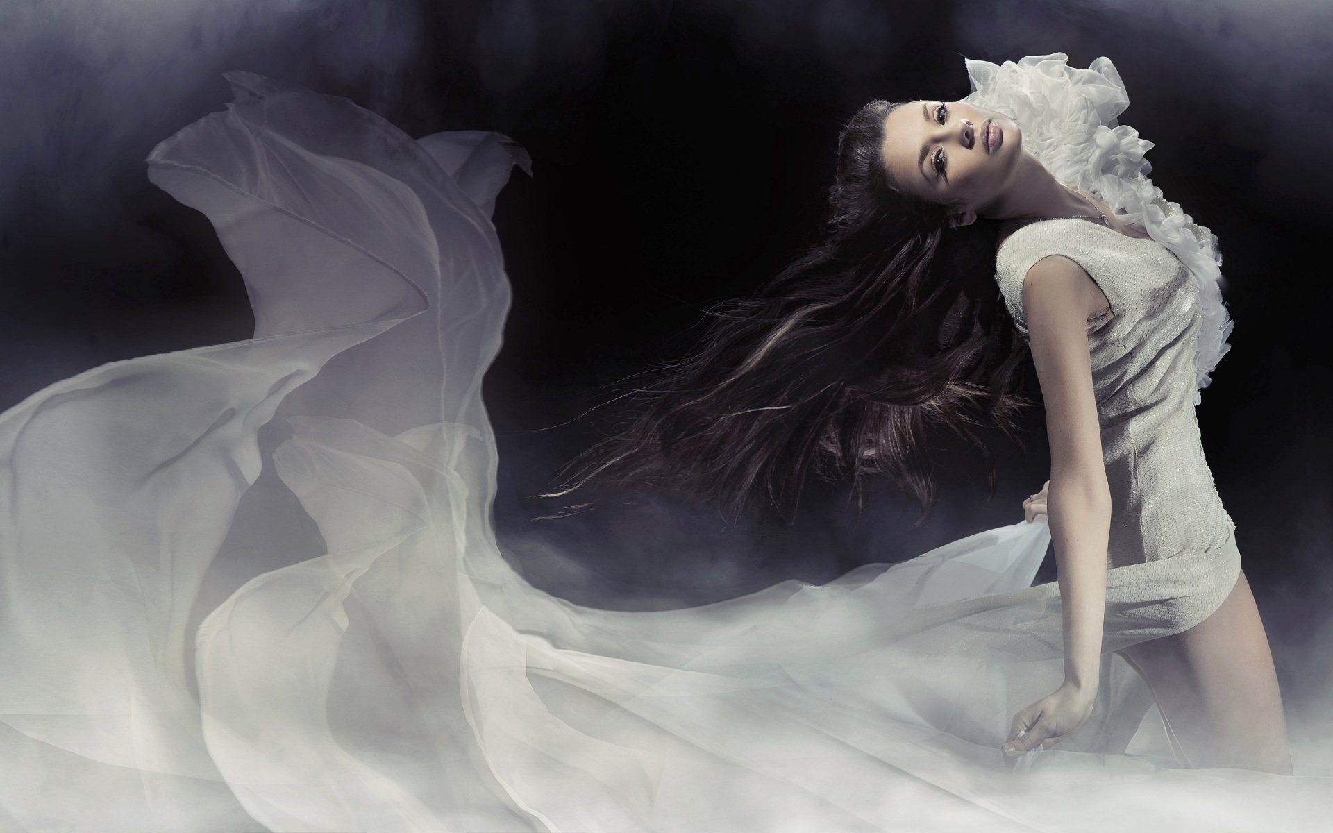 Artistic HD PC desktop wallpaper featuring a woman in flowing white fabric against a dark, smoky background, creating a dramatic and ethereal effect.