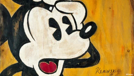 A vibrant HD desktop wallpaper featuring a painted image of Disney's iconic character Mickey Mouse against a yellow background. The artwork is signed by Kaminskii.