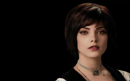 A striking HD wallpaper featuring a character from The Twilight Saga: Eclipse, showcasing her distinctive short dark hair and captivating eyes against a black background.