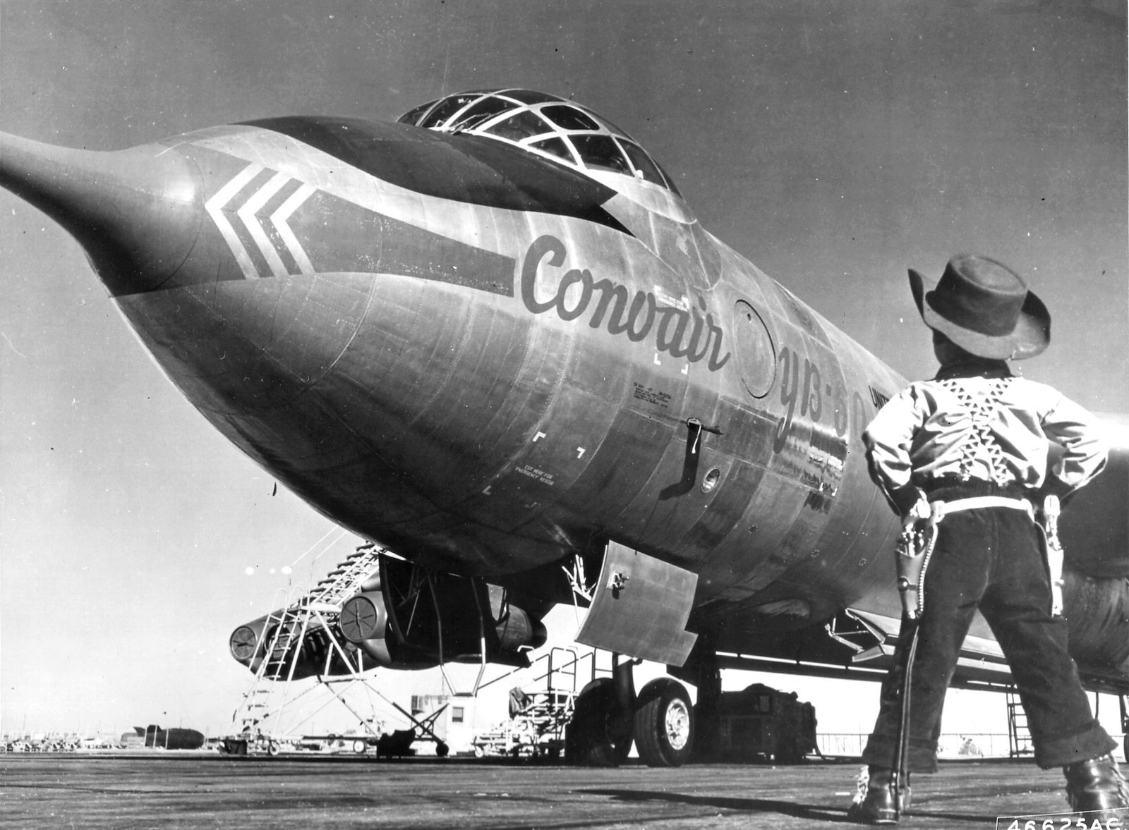 Black and white HD desktop wallpaper featuring a Convair YB-60 aircraft with a person standing nearby, highlighting its distinctive nose and cockpit design.
