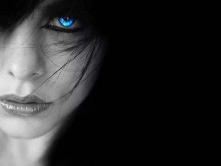 A HD wallpaper featuring a mysterious woman with piercing blue eyes and dark hair partially covering her face, evoking an intriguing and enigmatic atmosphere.