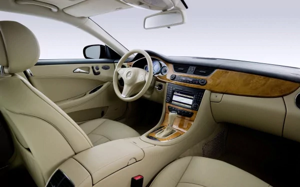 Interior view of a Mercedes-Benz CLS-Class with beige leather seats and wood trim, showcased as an HD PC desktop wallpaper and background.