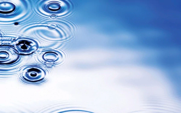 HD desktop wallpaper featuring ripples from water droplets in a serene blue setting, highlighting the beauty of nature.