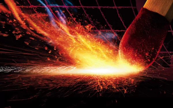 A high-definition desktop wallpaper featuring an artistic depiction of a match igniting, emitting vibrant flames and sparks, creating a dynamic and elemental visual effect.