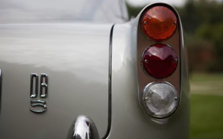 Close-up of the rear lights and DB5 badge on a silver Aston Martin DB5, captured in high definition for a PC desktop wallpaper and background.