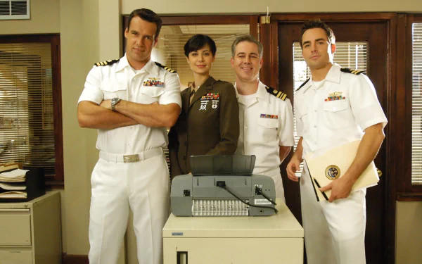 HD desktop wallpaper featuring the main cast of the TV show JAG dressed in military uniforms, standing together in an office setting.