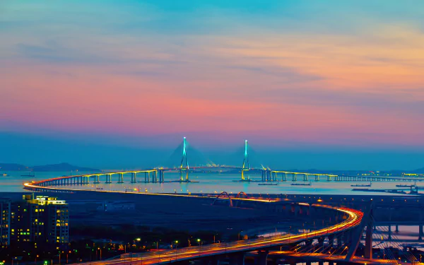 HD desktop wallpaper showcasing the man-made Incheon Bridge stretching across calm waters under a colorful sunset sky.