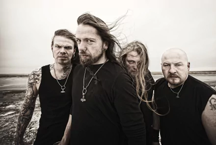 Moody monochrome portrait of metal band Týr on a windswept shore — music-themed 2K Quad HD PC desktop wallpaper/background.