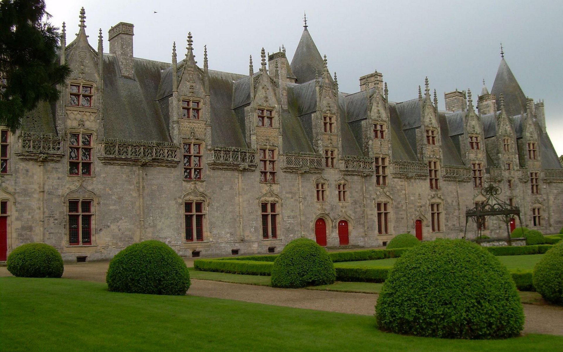 Man-made Josselin Castle: gray stone façade, steep turrets, slate roofs and trimmed formal gardens — HD PC desktop wallpaper and background.