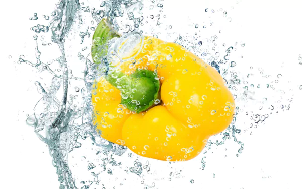 Vibrant yellow bell pepper submerged in water with bubbles, captured in high definition for a fresh food-themed PC desktop wallpaper.
