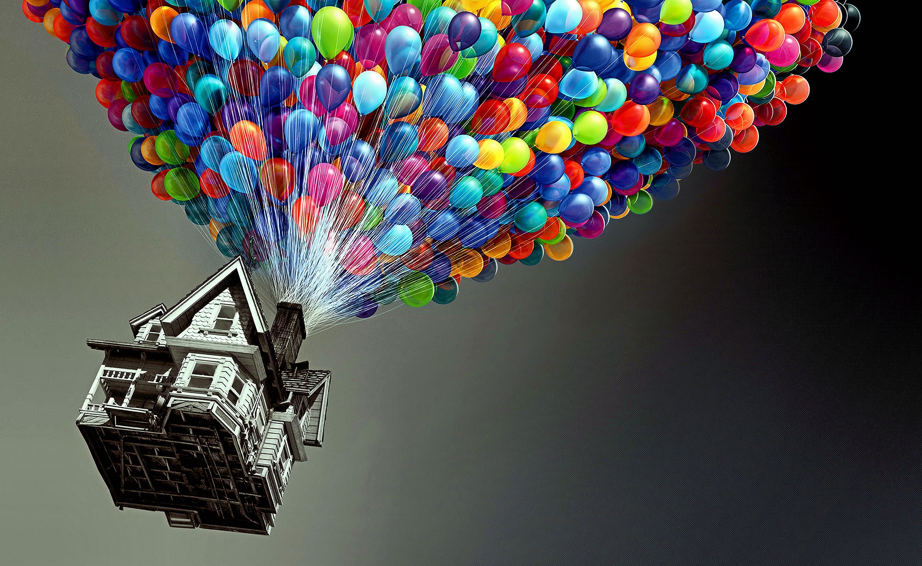 HD desktop wallpaper featuring a scene from the movie Up with a house lifted by countless colorful balloons.