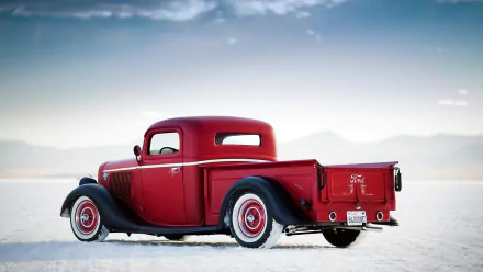 HD PC desktop wallpaper background of a red Ford Deluxe Pickup vehicle resting on a white salt flat beneath a pale sky.