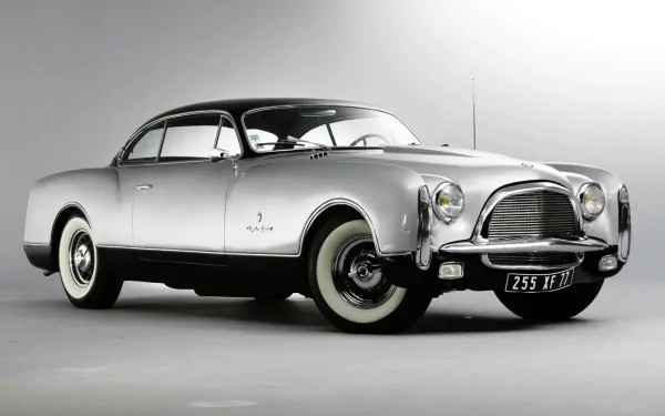 HD PC desktop wallpaper featuring a classic Chrysler vehicle in sleek silver, showcasing its vintage design and timeless elegance against a neutral background.