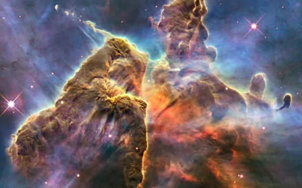 HD sci-fi desktop wallpaper: towering nebula gas pillars and swirling cosmic clouds in blue, orange and purple, dotted with bright stars and glowing light.