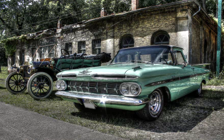 HD PC desktop wallpaper featuring a classic Chevrolet El Camino parked beside a vintage vehicle in front of an old, ivy-covered building.