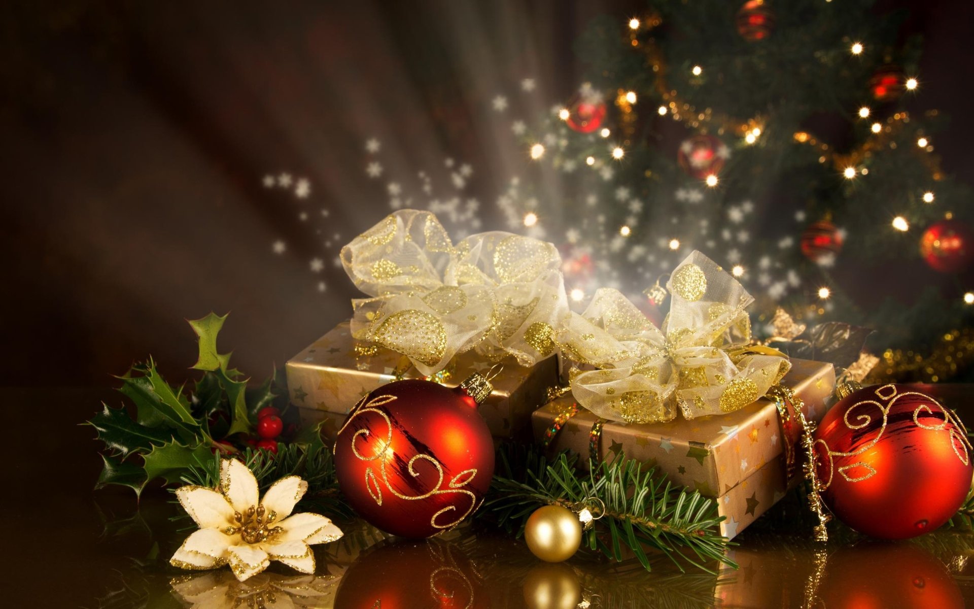 A beautifully arranged scene featuring gift boxes adorned with golden ribbons, vibrant Christmas ornaments, and festive greenery, capturing the warmth of the holiday season.