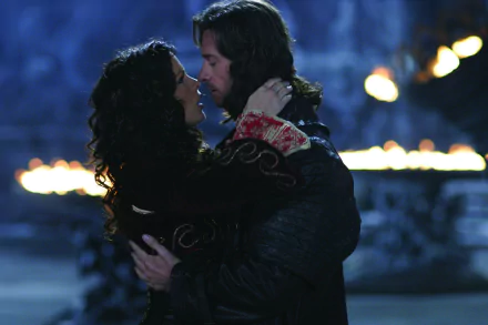 A romantic moment between Kate Beckinsale and Hugh Jackman in Van Helsing, captured in a dramatic HD PC desktop wallpaper, featuring a mystical backdrop and warm lighting.
