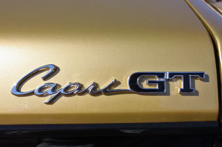 Close-up of the Mercury Capri GT emblem on a gold vehicle, presented as a 4K Ultra HD desktop wallpaper and background.