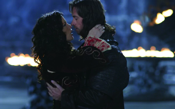 A romantic moment between Kate Beckinsale and Hugh Jackman in Van Helsing, captured in a dramatic HD PC desktop wallpaper, featuring a mystical backdrop and warm lighting.